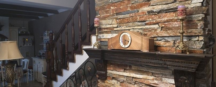 Unique fireplace decorated with slate cladding